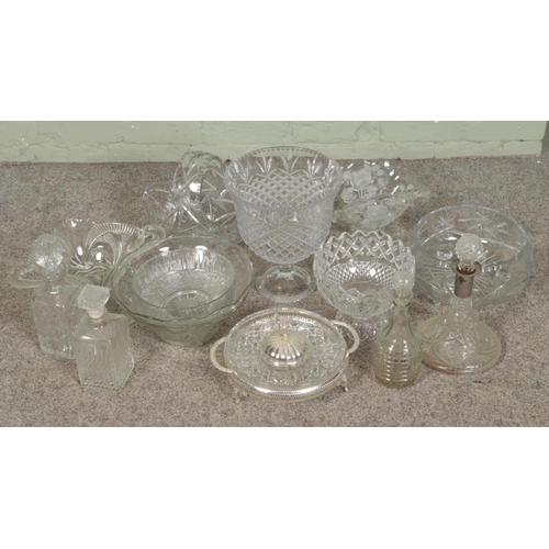 278 - A large quantity of cut glass items including large centre piece bowl, fruit bowls, decanters, hors ... 