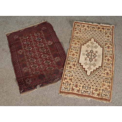 343 - A small red bokhara style rug together with another beige rug and two other examples 

Bokhara rug 1... 