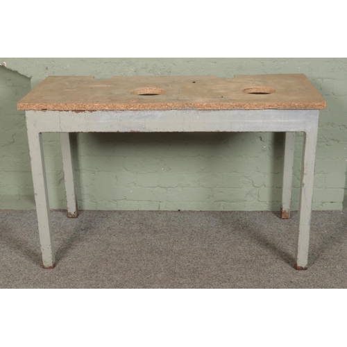 389 - A steel work bench with wooden chip board top.

Hx79cm
Wx128cm
Dx62cm