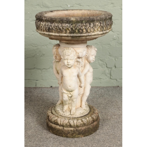 398 - A stone bird bath with a trio of cherubs/putti around the base 

Hx62cm