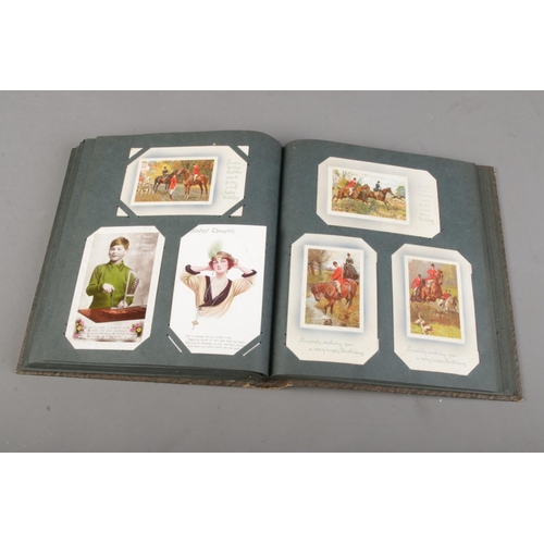 8 - An album of mostly early 20th century postcards of various themes including greetings, birthday and ... 