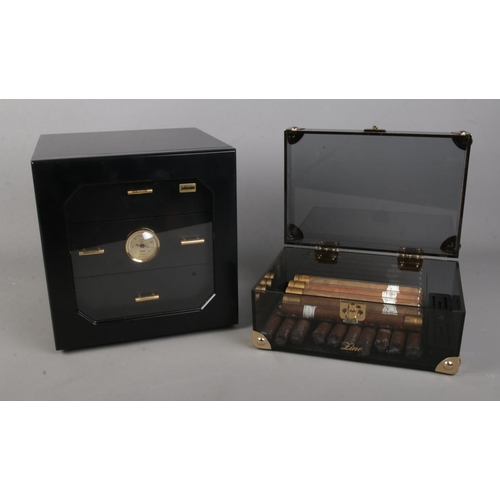 81 - A small matt black humidor by Adorini, can hold up to 100 cigars divided into 3 drawers with a hair ... 