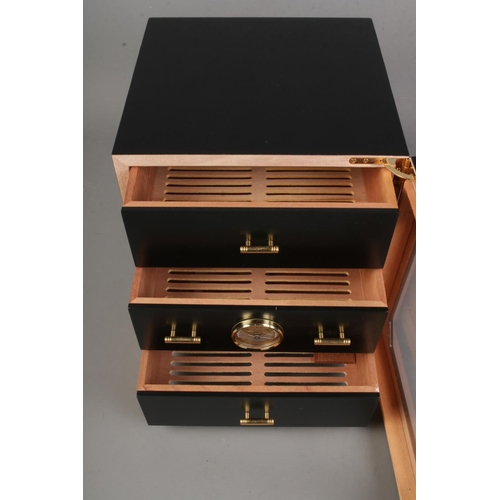 81 - A small matt black humidor by Adorini, can hold up to 100 cigars divided into 3 drawers with a hair ... 