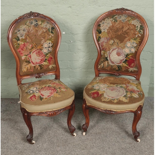 546 - A near pair of Victorian carved nursing chairs with tapestry style upholstery.