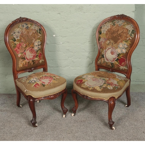 546 - A near pair of Victorian carved nursing chairs with tapestry style upholstery.