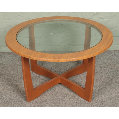 552 - A G Plan style circular coffee table with glass top.

Hx43cm
Dx76cm