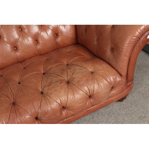 593 - A brown leather chesterfield type sofa raised on bun feet.

Length 250cm approx