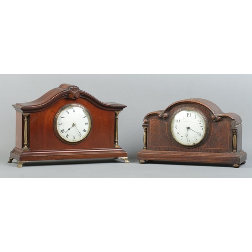 10 - Two wooden cased mantle clocks, both with brass column supports. To include an oak cased example wit... 