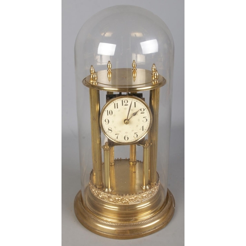120 - An ornate Badische Uhrenfabrik gilt mantel clock under glass dome. (45cm)