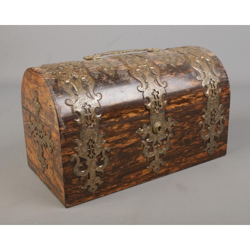 4 - A Victorian brass bound coromandel domed top tea caddy. The lock stamped for S Mordan & Co. Having t... 