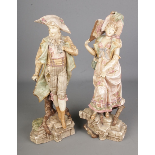 138 - A pair or ceramic figures in the style of Royal Dux. 

Hx46cm approx.