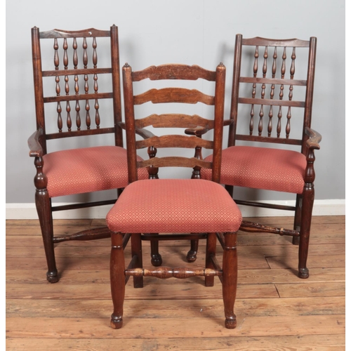 501 - A set of four ladder back dining chairs along with two similar carver examples.