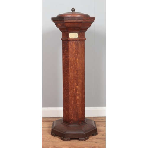 503 - An oak pedestal font of octagonal form, with metal bowl liner and lid. Bearing plaque to the inside ... 