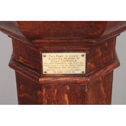 503 - An oak pedestal font of octagonal form, with metal bowl liner and lid. Bearing plaque to the inside ... 