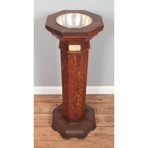 503 - An oak pedestal font of octagonal form, with metal bowl liner and lid. Bearing plaque to the inside ... 