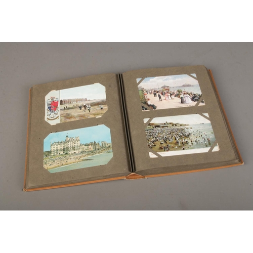 157 - A large album of late 19th/early 20th century British coastal themed postcards with Tucks, Shurey's,... 