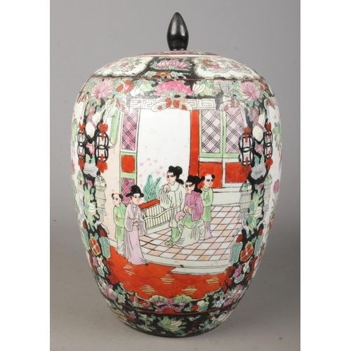 166 - An Oriental lidded vase. Having hand painted decoration depicting figures, birds and flowers. Height... 