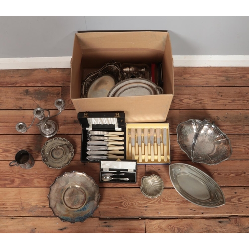 201 - A box of assorted metalwares, to include three branch candelabra, swing handled basket, lidded turee... 