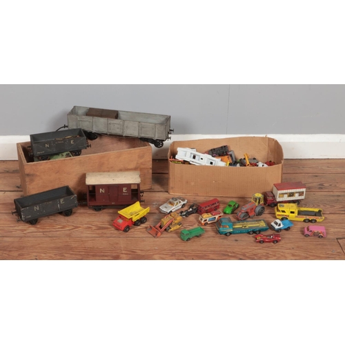 208 - Two boxes of vintage model vehicles, to include wooden railway carriages and a selection of diecast ... 