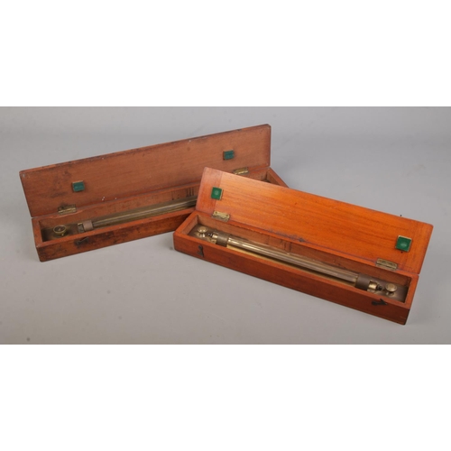 30 - Two wooden cased brass sliding rules; one marked for 'Drawing Office Supplies Ltd'.