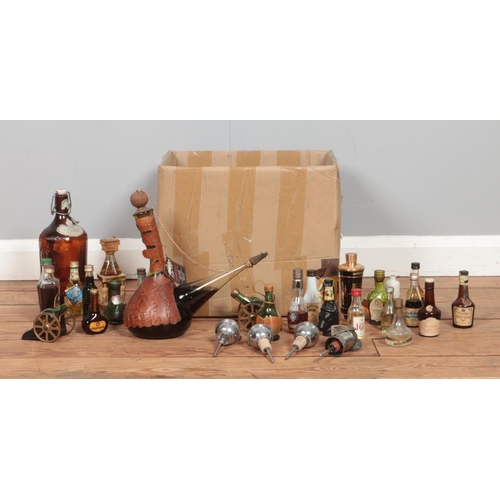 229 - A box of alcohol and alcohol miniatures, to include Malibu, Dorvell wine, Courvoisier and novelty wi... 