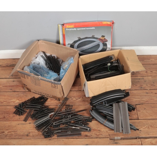 254 - Two boxes full of 00 gauge track including a Hornby electrically operated turntable.