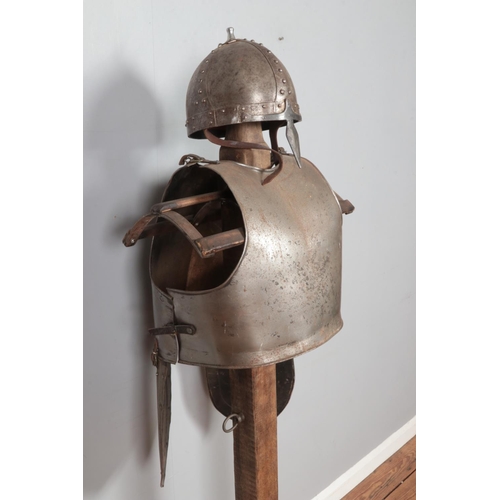 277 - A replica medieval Norman helmet and with breast & back plates with tassets attached displayed on cu... 