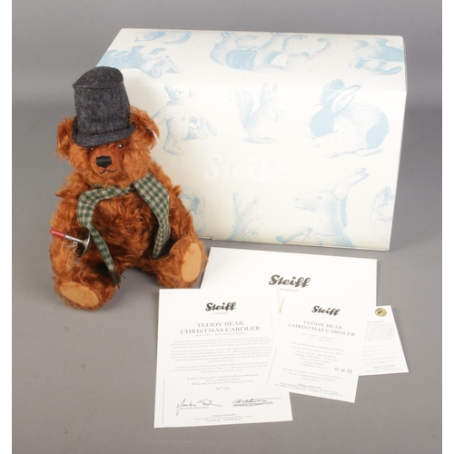 63 - A boxed limited edition Steiff mohair teddy bear titled Teddy Bear Christmas Caroler with top hat an... 