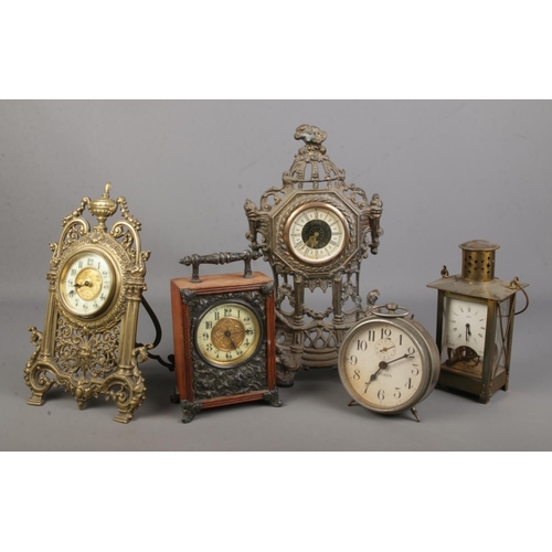 78 - A collection of clocks including Veglia and German brass examples.