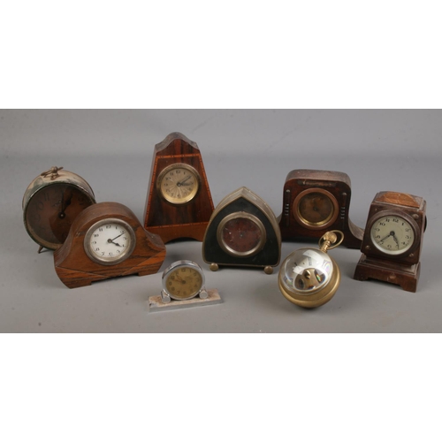 80 - A large collection of small clocks including several mantel clocks, bullseye clock, services competi... 