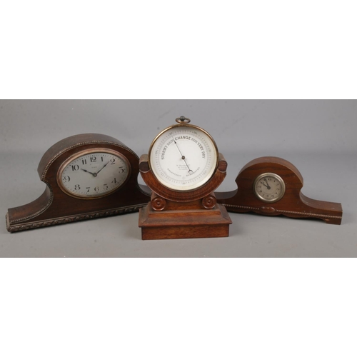 82 - A W Heath & Co barometer together with to oak cased mantel clocks.