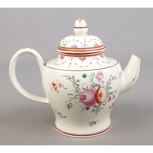 434 - A late 18th century porcelain teapot. Hand painted with flowers and inscribed Martha Eley, 1797.