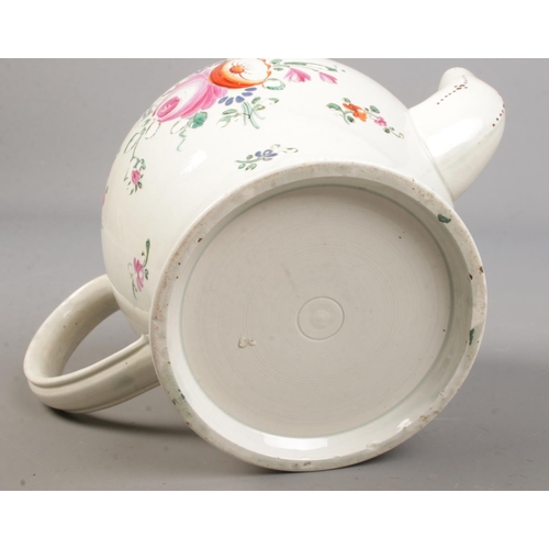 434 - A late 18th century porcelain teapot. Hand painted with flowers and inscribed Martha Eley, 1797.