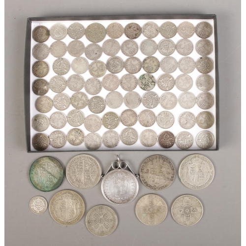 438 - A quantity of pre 1947 British silver coinage. Includes half crowns, florins and three pence pieces.... 