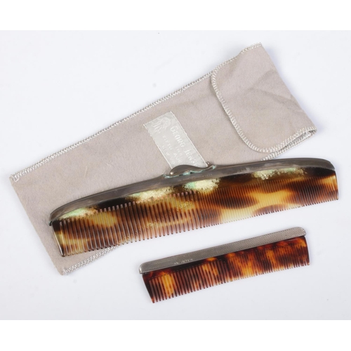 444 - A Georg Jensen silver and tortoise shell effect comb in sleeve, along with a similar smaller silver ... 