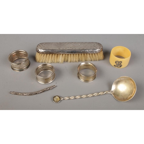 445 - A collection of silver to include napkin rings, spoon, brush, etc. Approx. silver only weight 70g. H... 