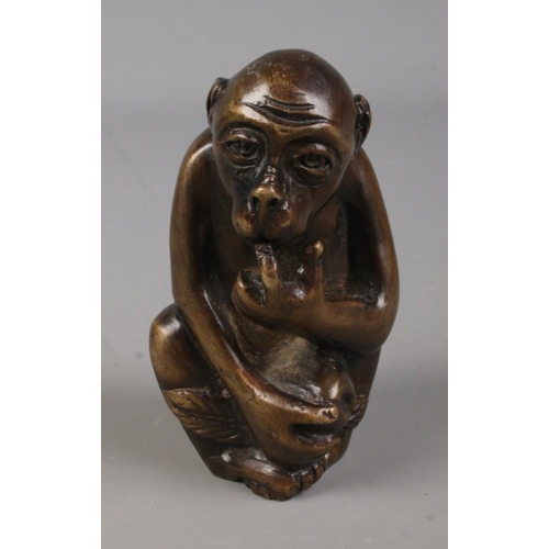 446 - A bronze figure formed as a seated monkey. Approx. height 8cm.