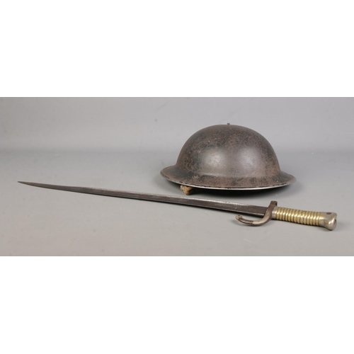 448 - An 1866 pattern French Chassepot sword bayonet, together with a Tommie/Brodie helmet with chin strap... 