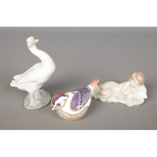 450 - A small collection of ceramic figures to include Royal Crown Derby Goldcrest bird paperweight and tw... 