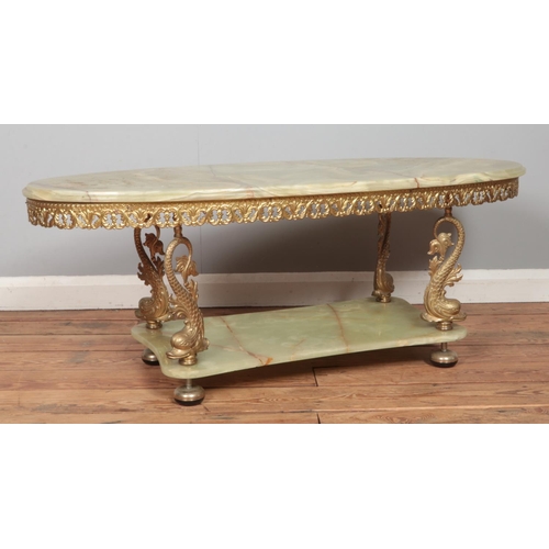 481 - A brass and onyx two tier coffee table, with dolphin supports. Height: 45cm, Width: 117cm, Depth: 50... 