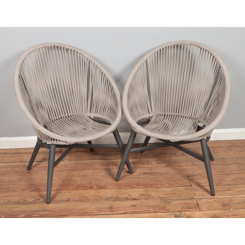 488 - A pair of garden tub chairs featuring rope work back and seat.