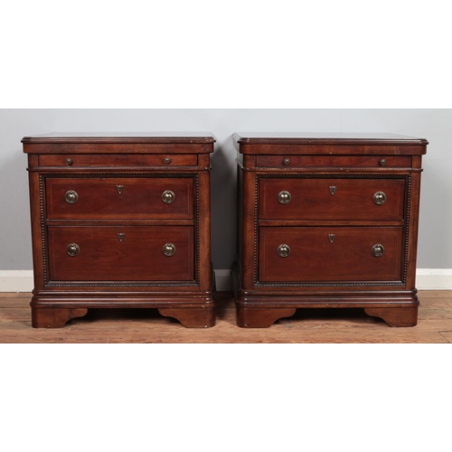 491 - A pair of Vietnamese made nightstands, with two drawers below a pull out tray. Both have 'Signature ... 