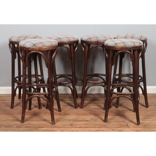 492 - A set of six bentwood bar stools, with chequered pattern fabric seat pads. Height: 78cm.