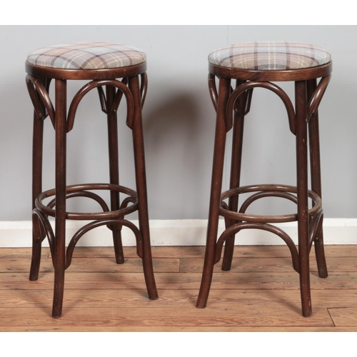 492 - A set of six bentwood bar stools, with chequered pattern fabric seat pads. Height: 78cm.