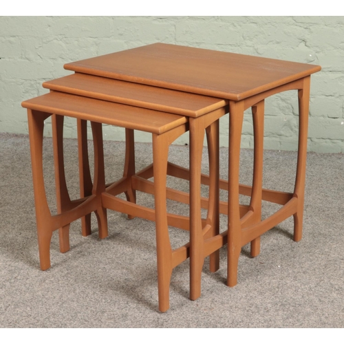 548 - A teak nest of three tables.