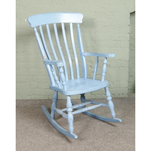 550 - A large painted pine rocking armchair.