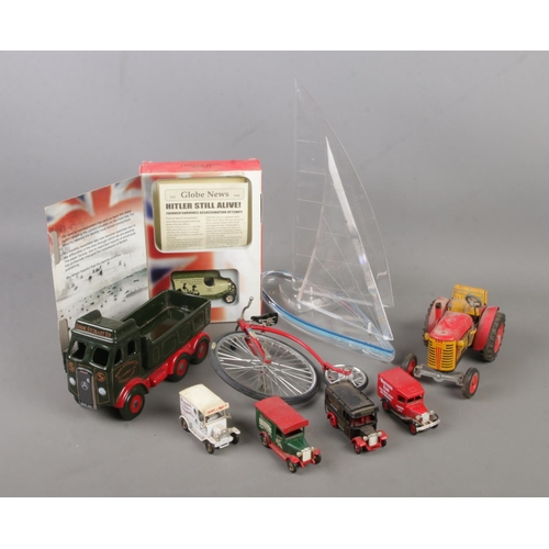 104 - A collection of model vehicles. Includes Wintrade sail boat, Wade Eddie Stobart truck, Zetor tractor... 