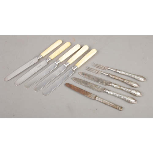 151 - A quantity of silver collared and silver handled flatware. To include five knives produced by Joseph... 