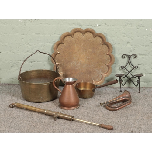 192 - A quantity of metalwares, including jam pan, copper bugle, copper half gallon jug and brass watering... 