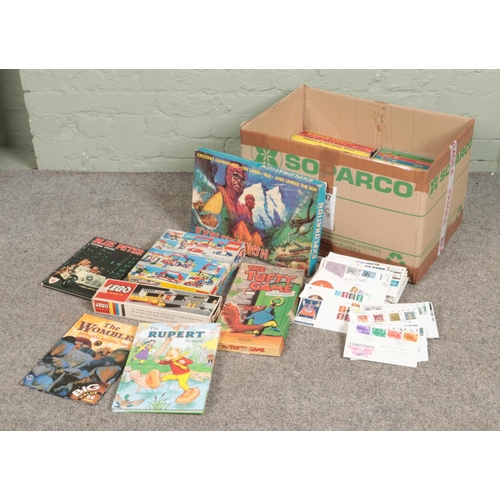 223 - A box of assorted children's toys, games and annuals to include Blue Peter, Lego, Disney Books, etc.... 